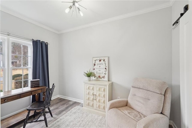 office with a barn door, ornamental molding, light wood-style flooring, and baseboards