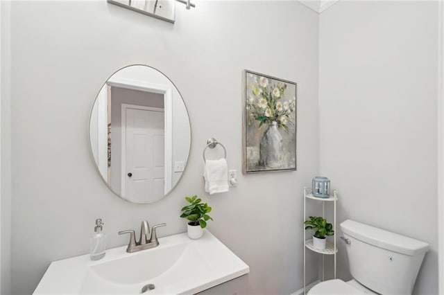 bathroom featuring toilet and vanity