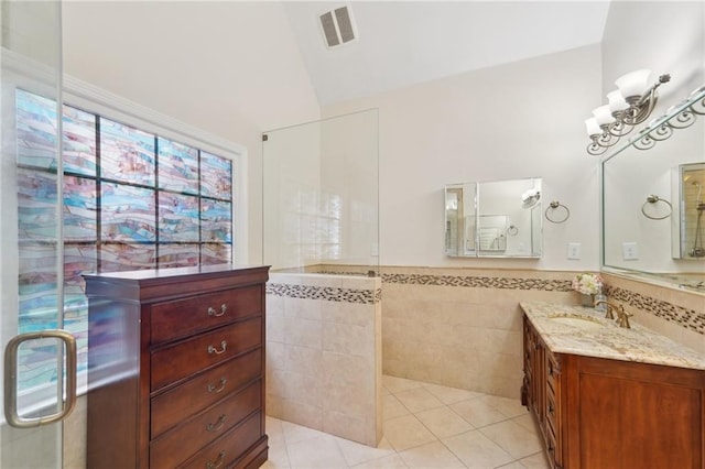 full bathroom with visible vents, wainscoting, tile patterned floors, vanity, and tile walls