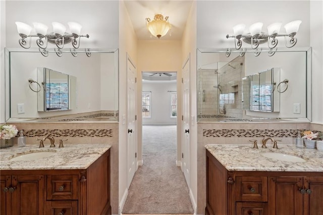 full bathroom featuring two vanities, a sink, and decorative backsplash