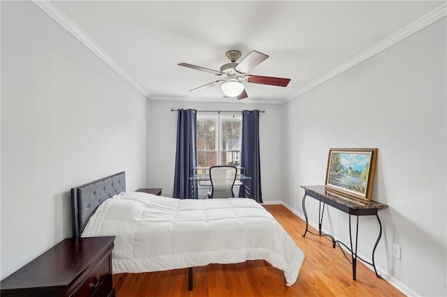 bedroom with ornamental molding, ceiling fan, baseboards, and wood finished floors