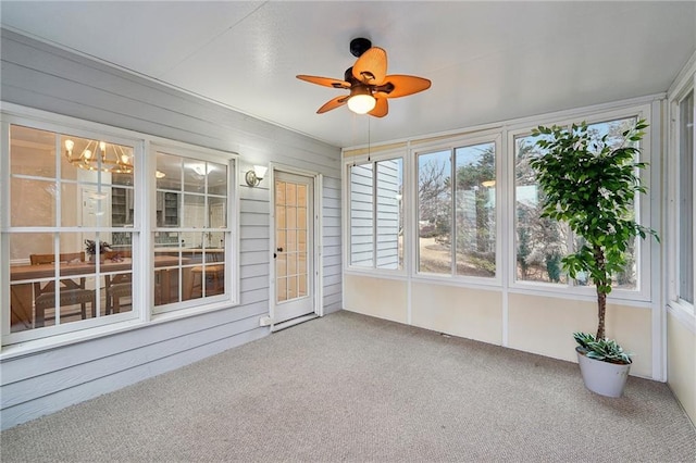 unfurnished sunroom featuring a ceiling fan