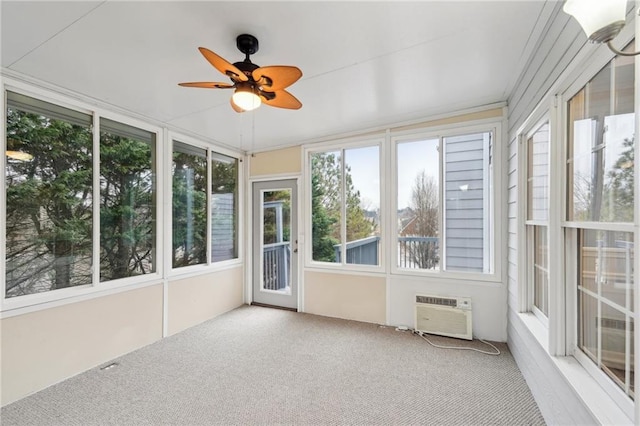 unfurnished sunroom with a wall unit AC and a ceiling fan