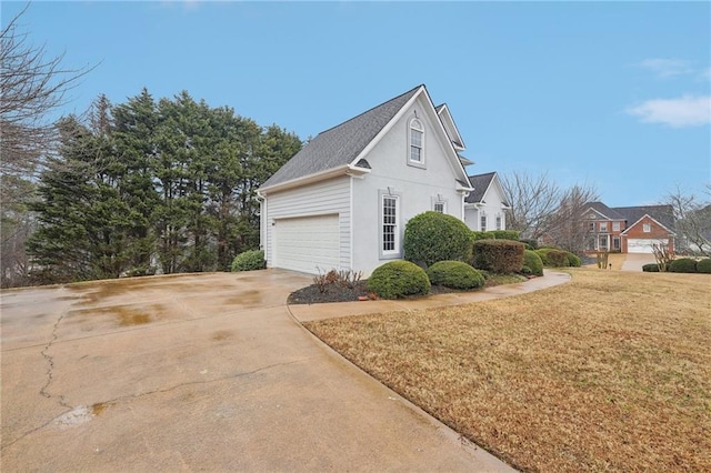 view of property exterior featuring concrete driveway, a lawn, and stucco siding