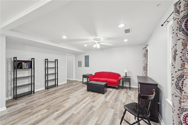 living area with light wood-style floors, recessed lighting, visible vents, and baseboards