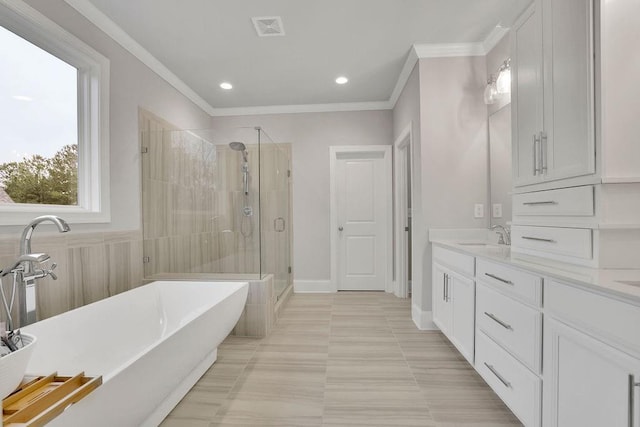 bathroom featuring visible vents, a stall shower, ornamental molding, a freestanding bath, and vanity