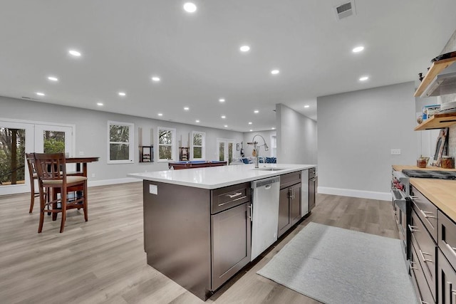 kitchen featuring visible vents, light countertops, recessed lighting, stainless steel appliances, and a sink