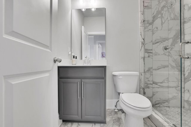 full bath featuring a marble finish shower, baseboards, toilet, marble finish floor, and vanity