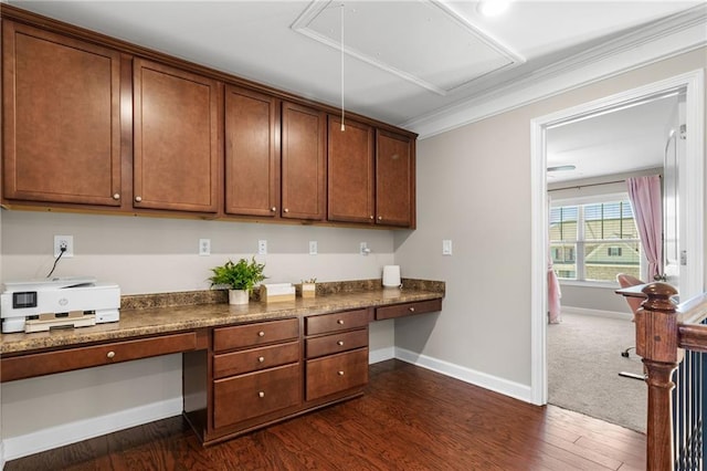 5115 Edgebrook Dr, Cumming, GA 30040 - kitchen with built in desk, dark countertops, dark wood-style flooring, and crown molding