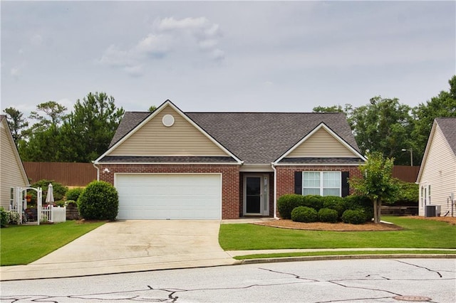 942 Village View Cir, Loganville, GA 30052 - traditional-style house featuring concrete driveway, an attached garage, brick siding, and a shingled roof