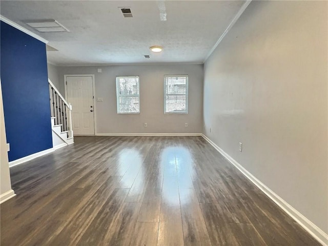 spare room with crown molding and dark hardwood / wood-style flooring