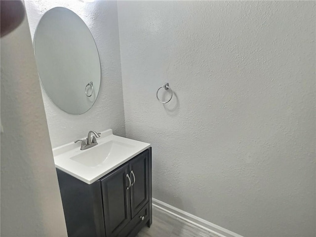 bathroom with vanity and wood-type flooring