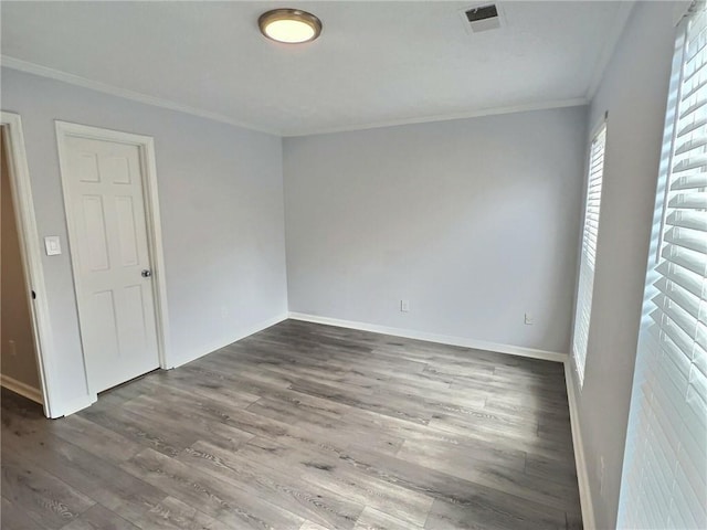 unfurnished bedroom featuring crown molding and wood-type flooring