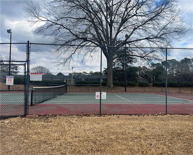 view of sport court with a lawn