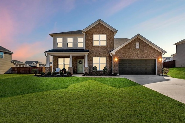 view of front of home with brick siding, a front lawn, fence, concrete driveway, and a garage