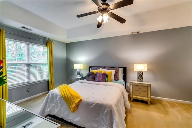 bedroom featuring visible vents, light carpet, and baseboards