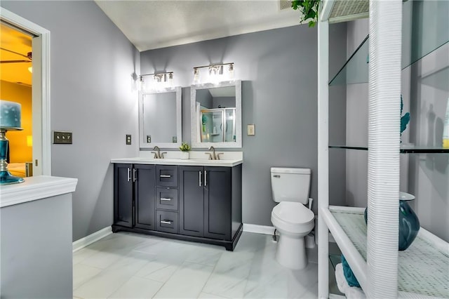 bathroom featuring a sink, toilet, and baseboards