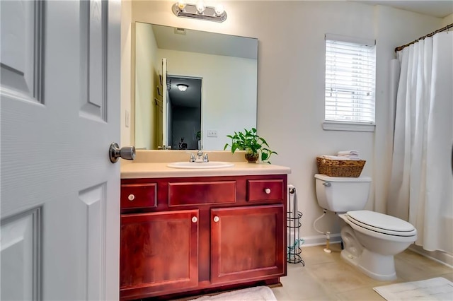 bathroom featuring toilet, tile patterned flooring, baseboards, and vanity