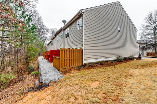 view of home's exterior featuring fence