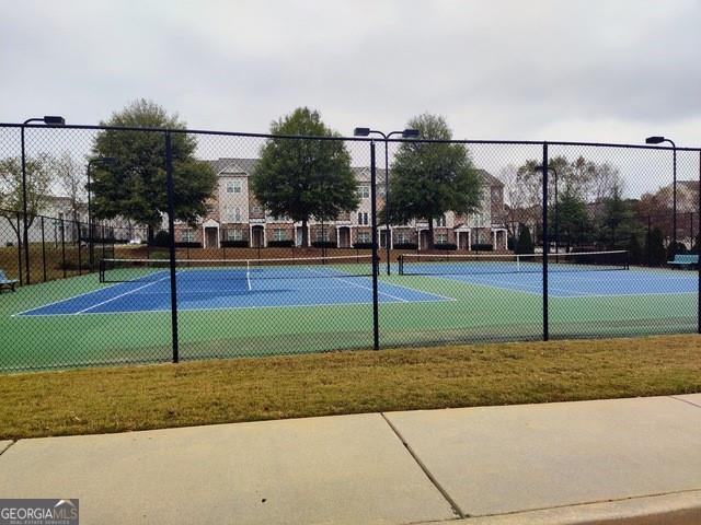 view of tennis court with fence