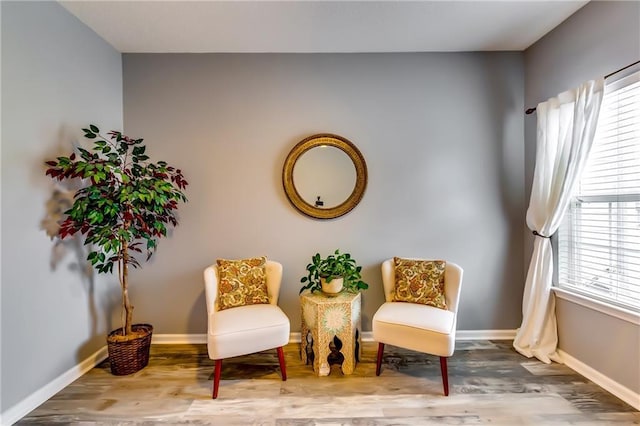 living area with wood finished floors and baseboards