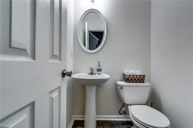 half bath with toilet and baseboards