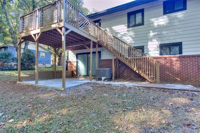 rear view of property featuring central AC unit, a patio area, and a wooden deck