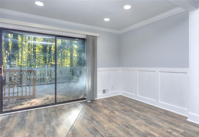 spare room with dark hardwood / wood-style flooring and ornamental molding