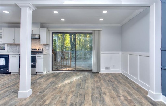 interior space with ornate columns, dark wood-type flooring, and crown molding