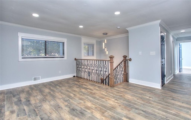 empty room with dark hardwood / wood-style floors and ornamental molding