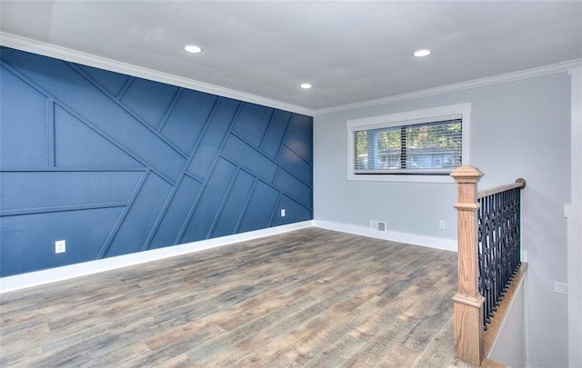 unfurnished room with hardwood / wood-style floors and crown molding