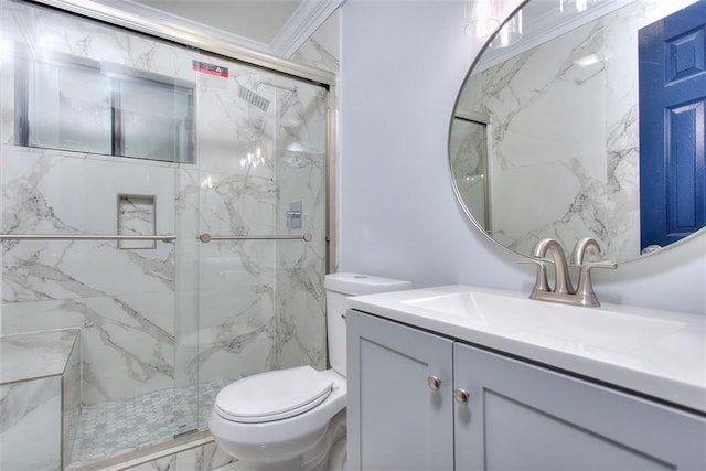 bathroom featuring vanity, toilet, ornamental molding, and a shower with shower door