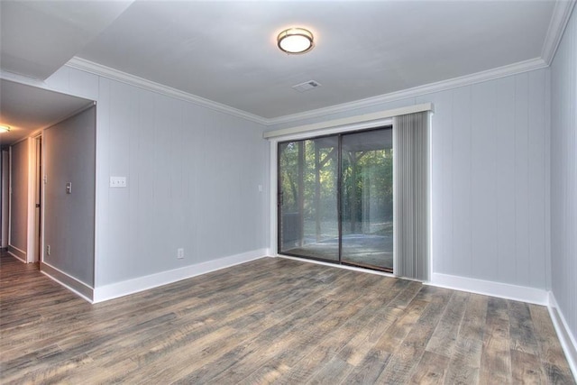 spare room featuring dark hardwood / wood-style flooring and ornamental molding