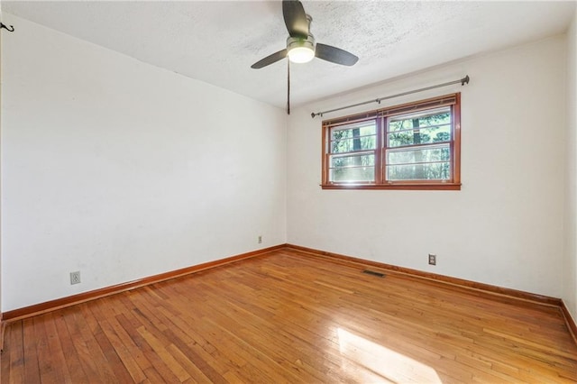 empty room featuring ceiling fan and light wood-type flooring