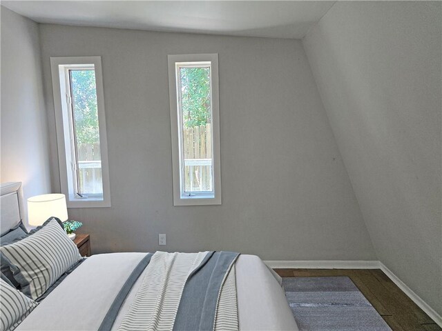 1920 Moores Mill Rd NW, Atlanta, GA 30318 - bedroom featuring multiple windows, baseboards, and dark wood-style flooring