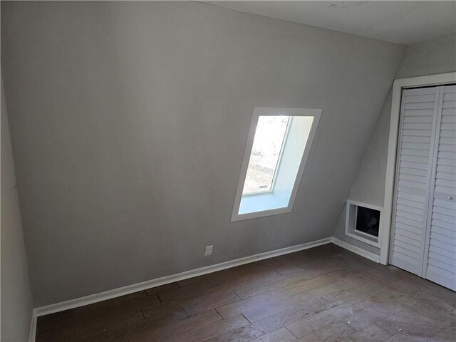 1920 Moores Mill Rd NW, Atlanta, GA 30318 - unfurnished living room with baseboards, dark wood-style flooring, and lofted ceiling