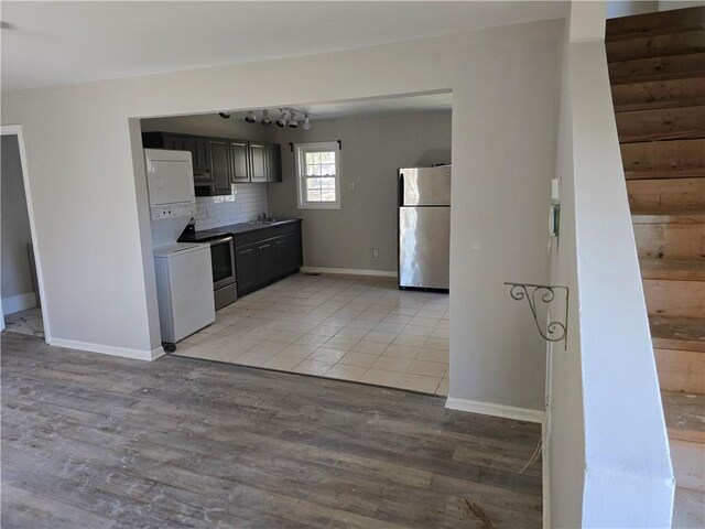 1920 Moores Mill Rd NW, Atlanta, GA 30318 - kitchen featuring decorative backsplash, range, light wood-type flooring, and freestanding refrigerator