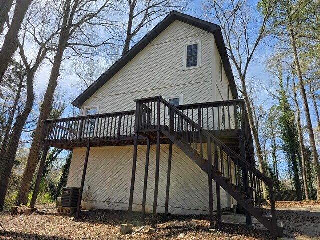 1920 Moores Mill Rd NW, Atlanta, GA 30318 - view of home's exterior featuring central AC, a wooden deck, and stairway