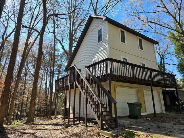 1920 Moores Mill Rd NW, Atlanta, GA 30318 - back of house with an attached garage, stairs, a wooden deck, and cooling unit