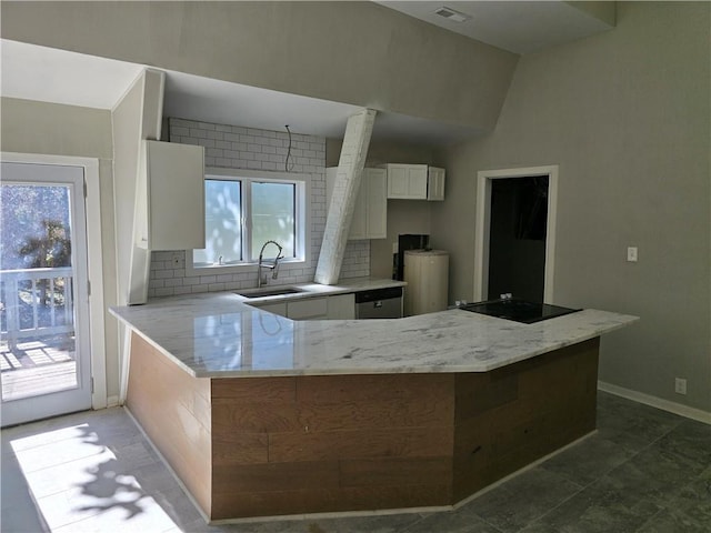 1920 Moores Mill Rd NW, Atlanta, GA 30318 - kitchen with a sink, a peninsula, light stone countertops, and a wealth of natural light