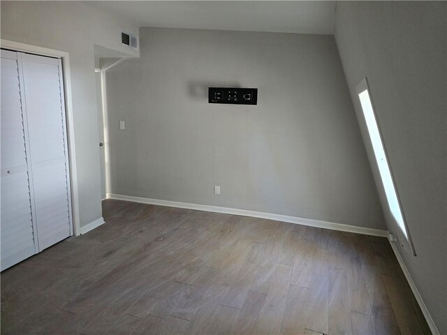 1920 Moores Mill Rd NW, Atlanta, GA 30318 - unfurnished bedroom featuring baseboards, visible vents, wood finished floors, and a closet