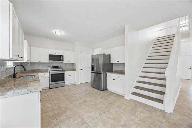 3405 Summer Brooke Way, Union City, GA 30291 - kitchen with appliances with stainless steel finishes, backsplash, white cabinets, light stone countertops, and a textured ceiling