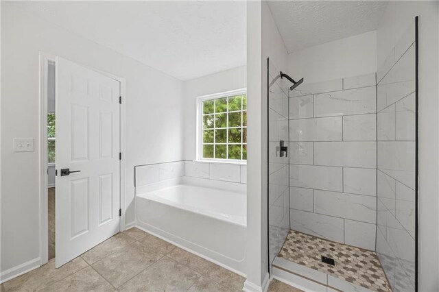 3405 Summer Brooke Way, Union City, GA 30291 - bathroom featuring a bath, a shower stall, a textured ceiling, and tile patterned flooring