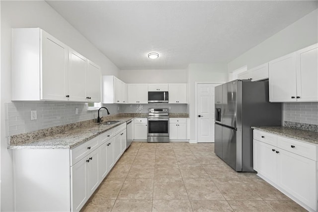 3405 Summer Brooke Way, Union City, GA 30291 - kitchen featuring appliances with stainless steel finishes, tasteful backsplash, white cabinets, and a textured ceiling