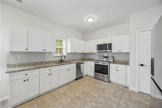 3405 Summer Brooke Way, Union City, GA 30291 - kitchen with appliances with stainless steel finishes, backsplash, white cabinetry, and a textured ceiling