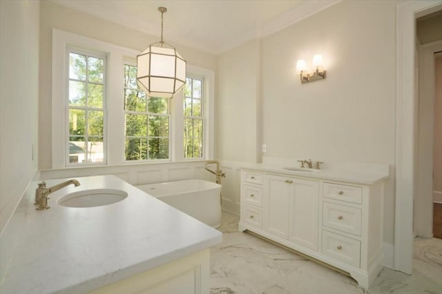 bathroom featuring vanity, marble finish floors, and a soaking tub