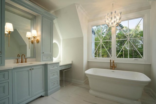 bathroom featuring a chandelier, vanity, a soaking tub, and plenty of natural light