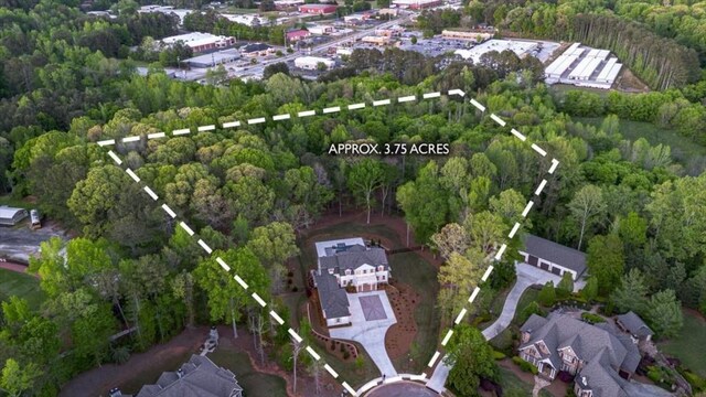aerial view of property's location featuring a forest and property parcel outlined