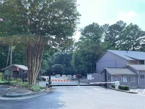 3828 Woodridge Way, Tucker, GA 30084 - view of asphalt road with curbs, a gated entry, and a gate