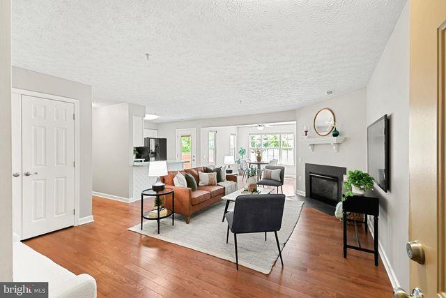 3828 Woodridge Way, Tucker, GA 30084 - living area featuring a textured ceiling, wood finished floors, and a fireplace
